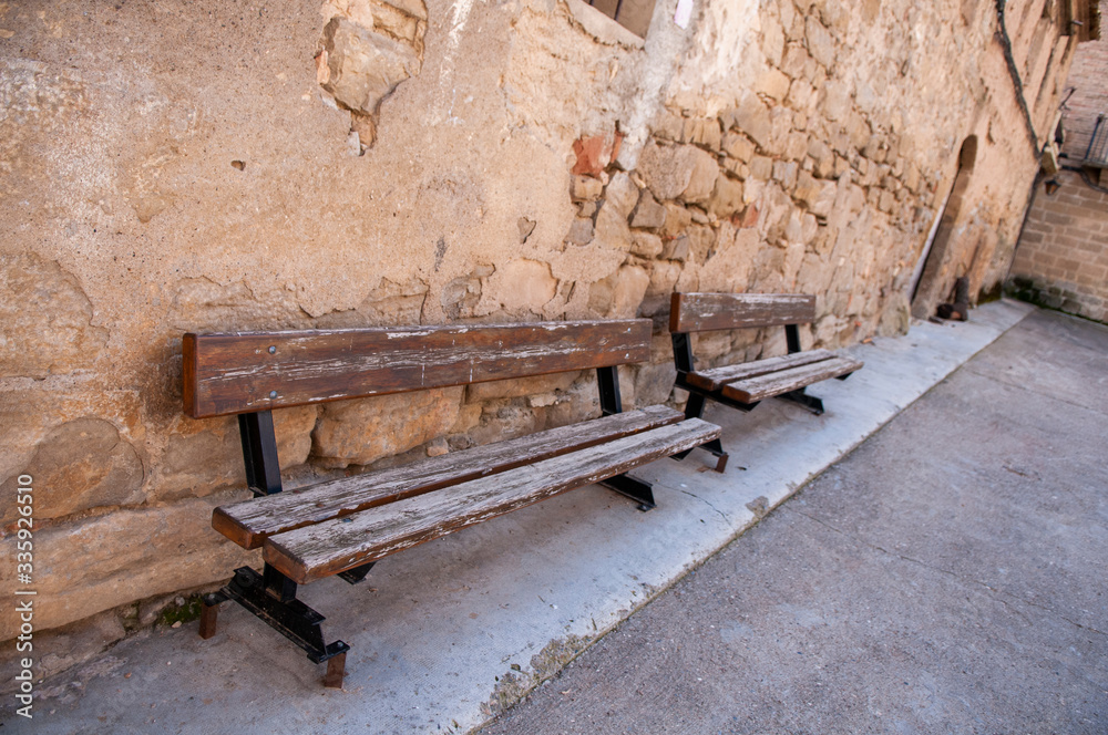 Brown wooden benches on the street Brown wooden benches on the street
