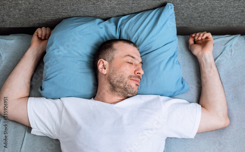 Mature Man Sleeping Lying In Bed In Bedroom, Top View