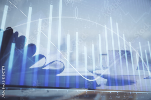 Double exposure of financial chart drawing and desktop with coffee and items on table background. Concept of forex market trading