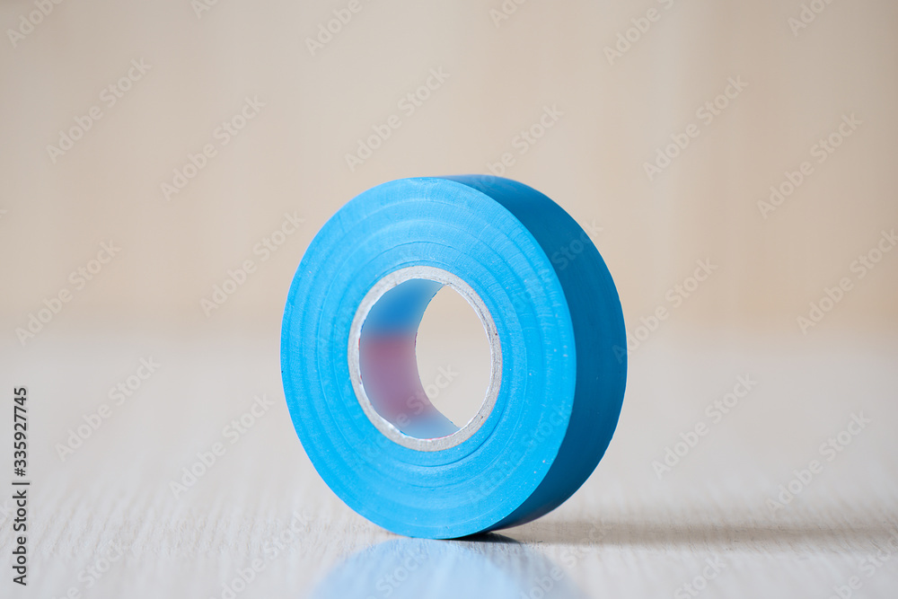 Foto Stock Blue insulating tape to insulate the twist of electrical wires. Adobe Stock