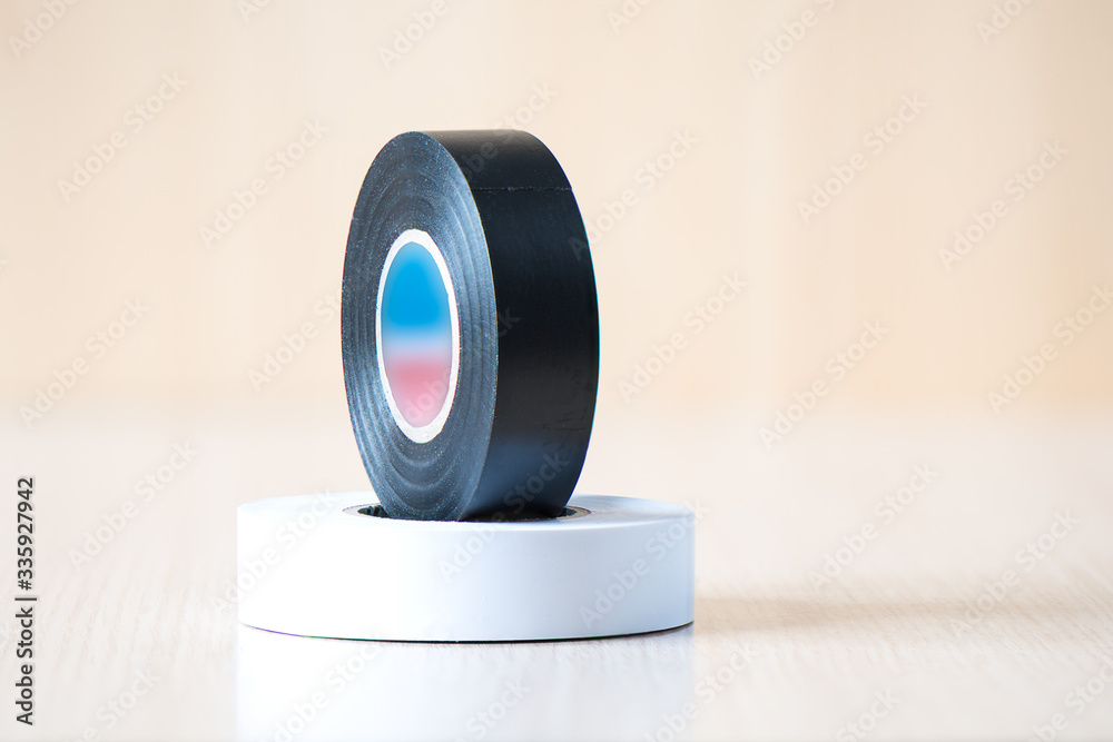 Black and white insulating tapes to insulate the twist of electrical wires. Stock Photo Adobe