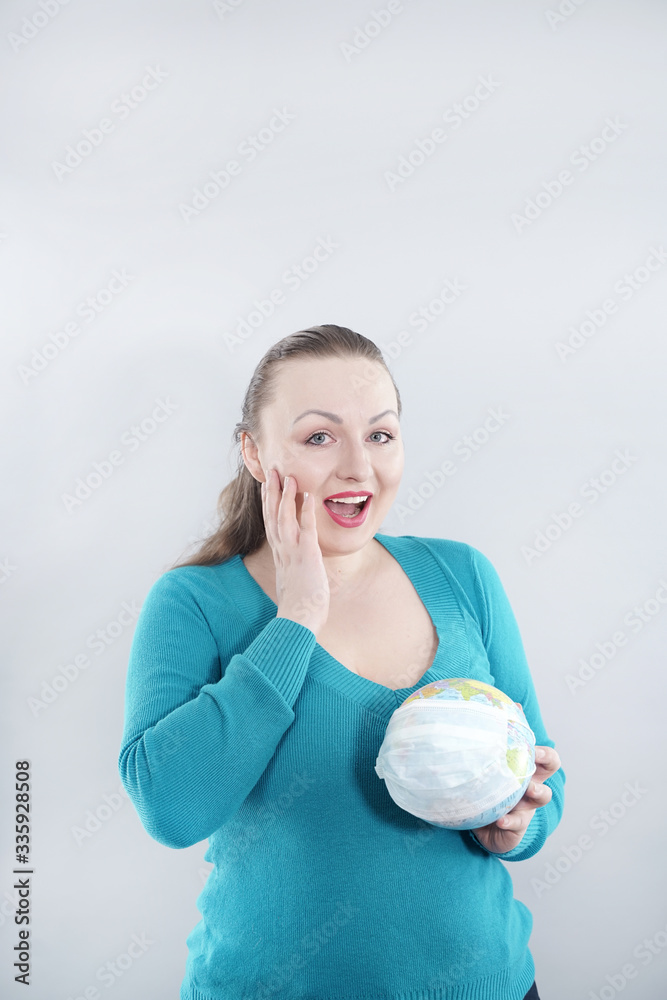 Global Flu Pandemic Concept. Woman with world globe With Medical Mask on white studio background. Global Flu Pandemic Concept. Woman with world globe With Medical Mask on white studio background.
