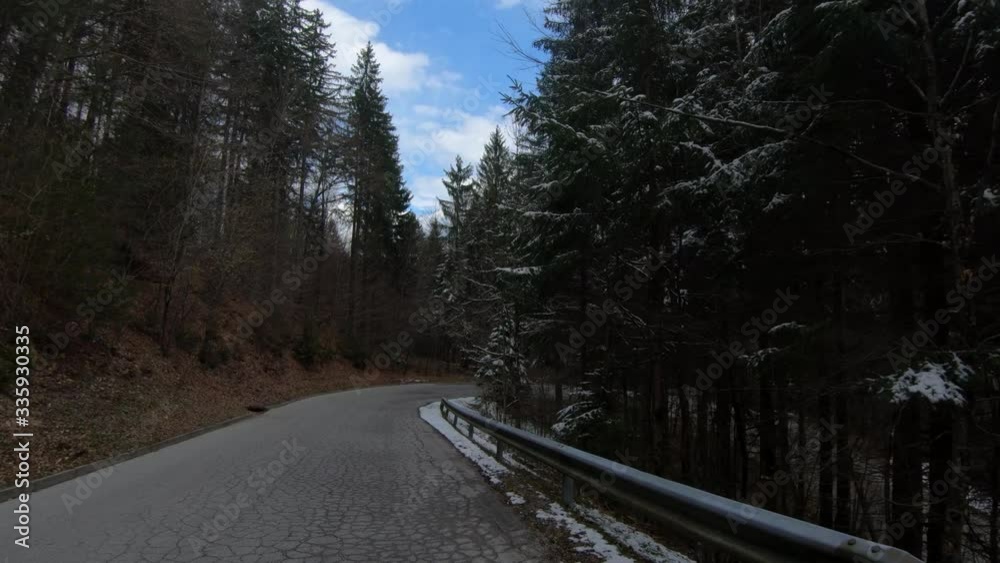 POV Point of view riding the bike descending on empty countryside road between forest tree in Slovenia POV Point of view riding the bike descending on empty countryside road between forest tree in Slovenia