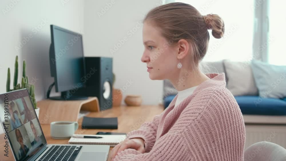 Woman Greets and Talks with 4 People at Video Chat using Laptop. Online Group Video Call Conference of Work Team from Home Office. Self-isolation at COVID-19 Pandemic. 4K Medium Orbit Shot