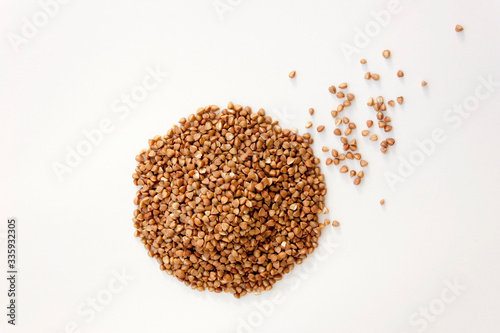 Buckwheat isolated on a white background. Useful cereals for cooking soups and porridges. © Дмитрий Бондаренко