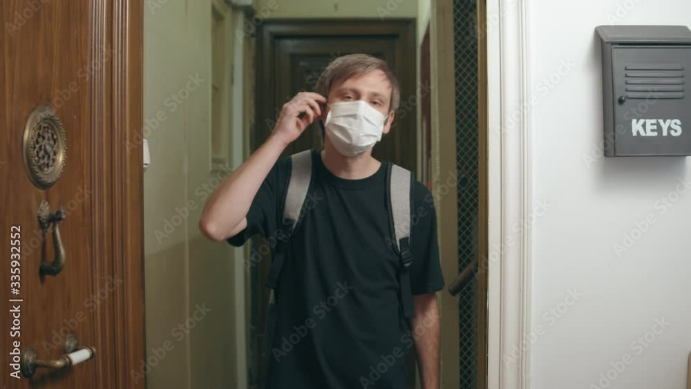 Man come back home after coronavirus pandemic, tourist in medical mask went home after quarantine and home isolation, open boarders, happy end of covid 19, went back and return to family