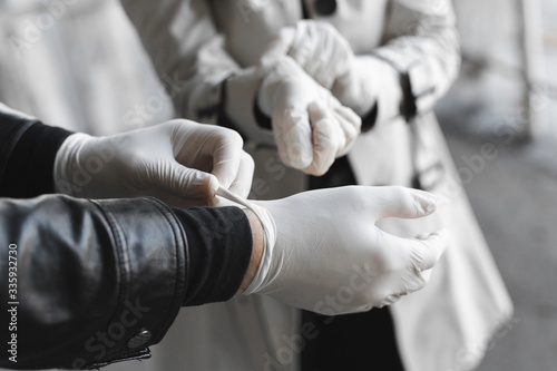 Man and woman wears medical gloves to be safe from the outbreak of novel coronavirus.Wearing hand gloves can prevent the covid-19 coronavirus
