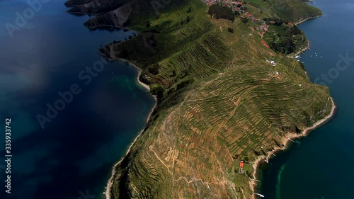 Aerial tilt up shot of Sun Island (Spanish: Isla del Sol ) on Lake Titicaca, the highest navigable lake in the world, on the border of Peru and Bolivia, South America.