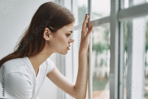 portrait of a young woman looking at the window