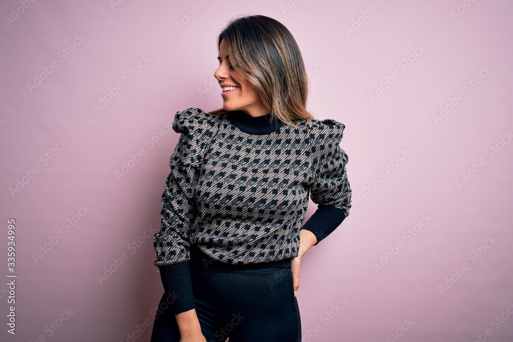 Young beautiful woman wearing fashion urban clothes, model wearing casual street style standing over pink background Young beautiful woman wearing fashion urban clothes, model wearing casual street style standing over pink background