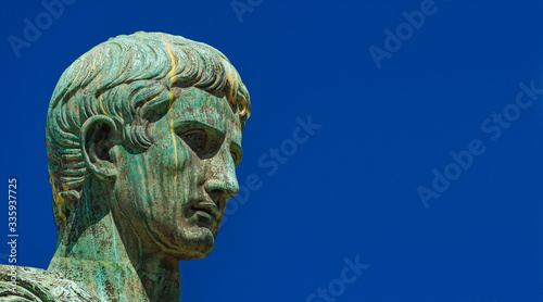 Caesar Augustus, first emperor of Ancient Rome and father of the nation. Old bronze statue along the Imperial Forum Road (with copy space)