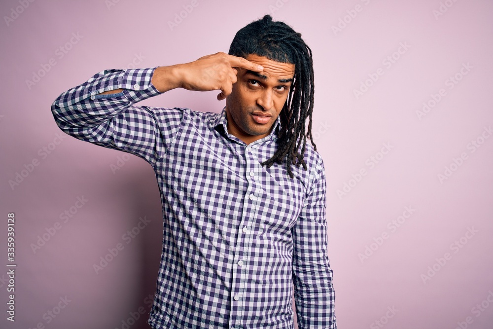 Young handsome african american afro man with dreadlocks wearing casual shirt pointing unhappy to pimple on forehead, ugly infection of blackhead. Acne and skin problem Young handsome african american afro man with dreadlocks wearing casual shirt pointing unhappy to pimple on forehead, ugly infection of blackhead. Acne and skin problem