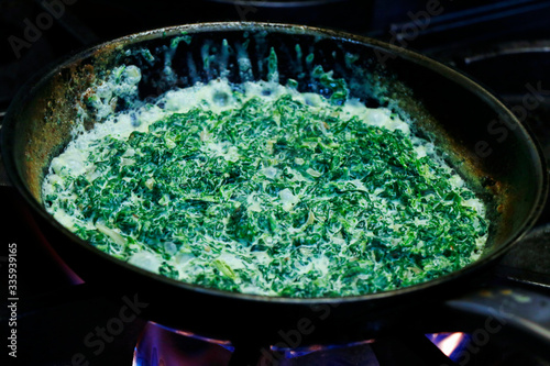 creamy saute spinach in a hot pan