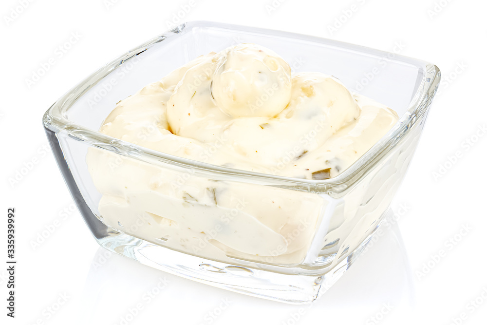 Tartar sauce with onions and pickled cucumbers in a small transparent glass square bowl isolated on white background Tartar sauce with onions and pickled cucumbers in a small transparent glass square bowl isolated on white background