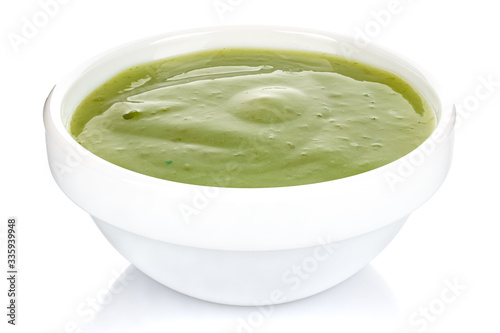 Green chili sauce with lime in a small white ceramic round bowl isolated on white background