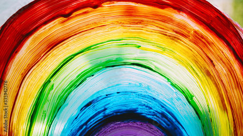 Close-up photo of painting rainbow on window photo