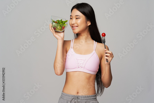 young woman holding a salad © SHOTPRIME STUDIO