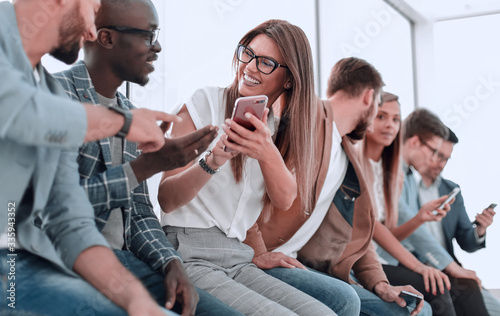 group of young people with smartphones