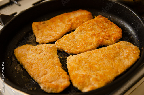 Breaded chicken cutlets in a pan