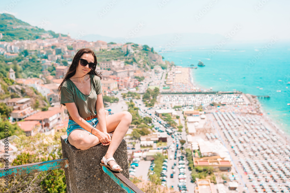 Young woman in background of mediterranean sea and sky.