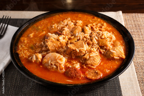 A view of a bowl of jambalaya, in a restaurant or kitchen setting.