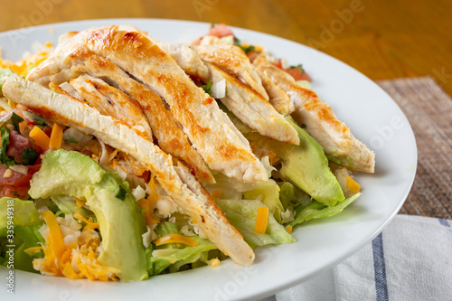 A closeup view of a chicken salad plate, in a restaurant or kitchen setting.