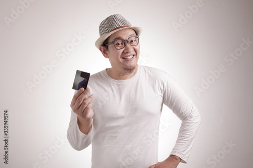 Happy Young Man Smiling and Pointing Credit Card