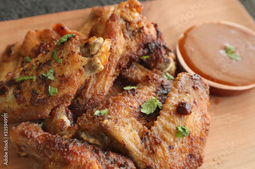 Delicious chicken wings, baked or fried chicken wings served with hot spicy  barbeque sauce