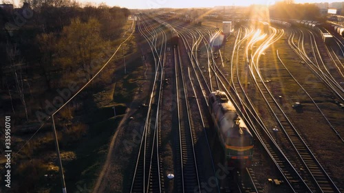 train at the fork of the tracks at sunset aerial view. photo