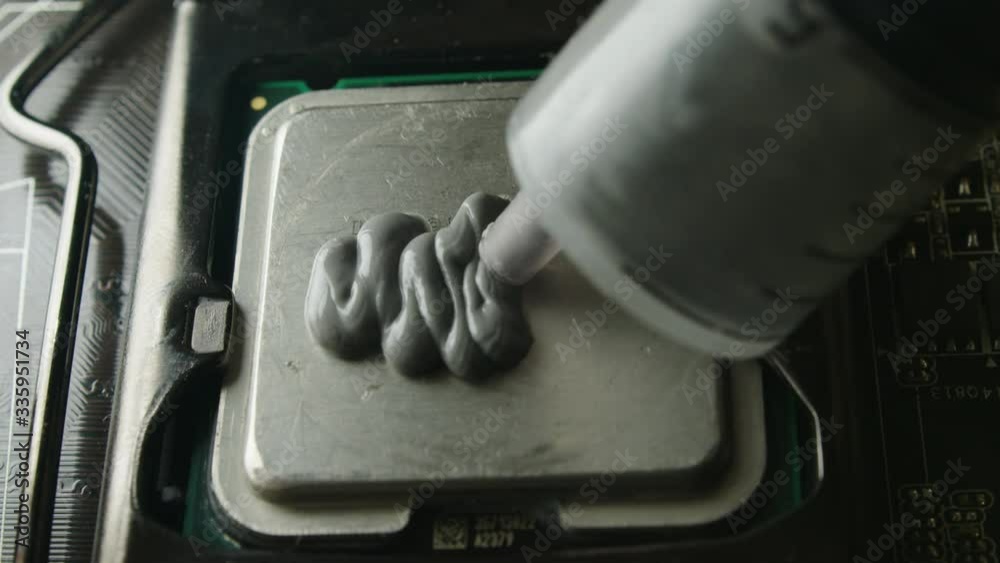 Build computer concept. Close-up shot of applying thermal paste on CPU. 4k footage.