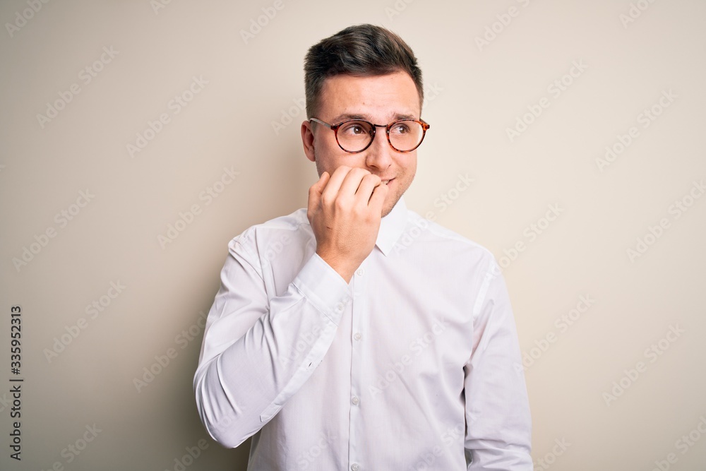Young handsome business mas wearing glasses and elegant shirt over isolated background looking stressed and nervous with hands on mouth biting nails. Anxiety problem. Young handsome business mas wearing glasses and elegant shirt over isolated background looking stressed and nervous with hands on mouth biting nails. Anxiety problem.