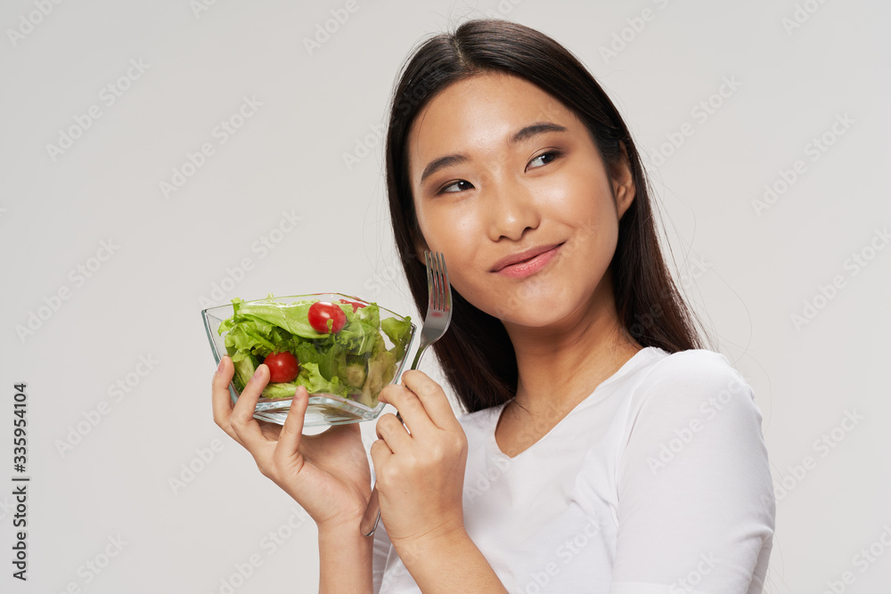 young woman holding bowl of salad young woman holding bowl of salad