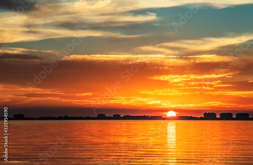 Indian Beach 5, Sarasota, Florida, beautiful orange, red sunset, visible sun, ripples, clouds  © Renee