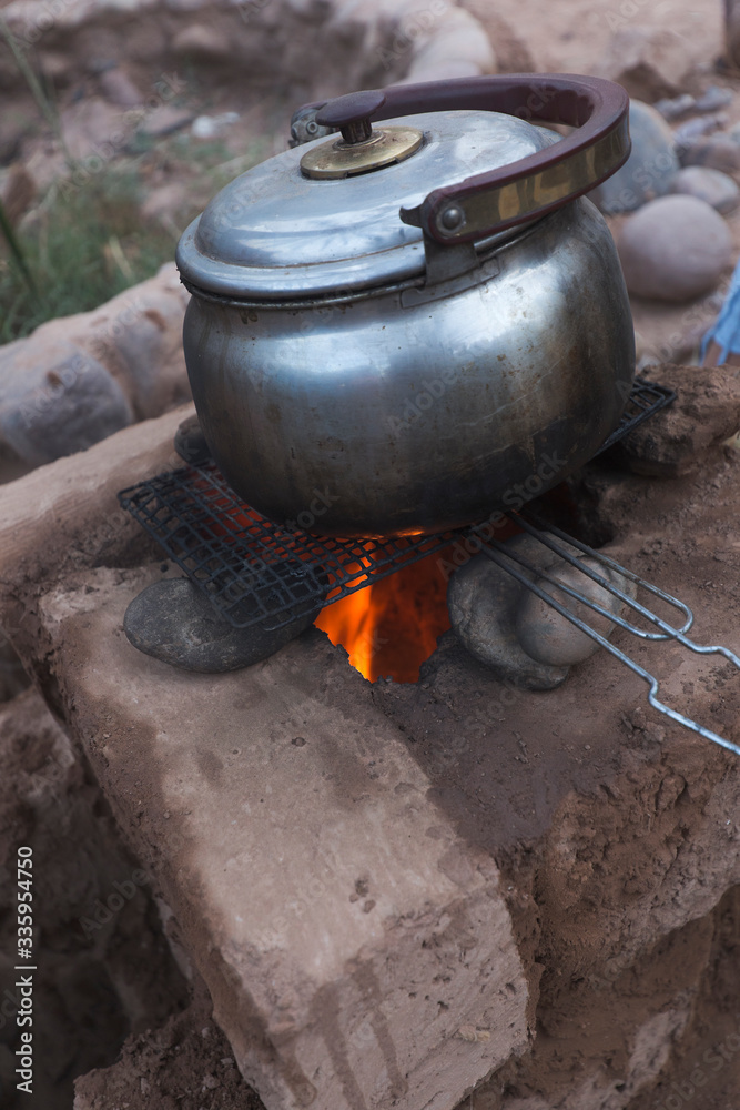 Cooking in a clay rocket kitchen in M'Hamid El Ghizlane Cooking in a clay rocket kitchen in M'Hamid El Ghizlane