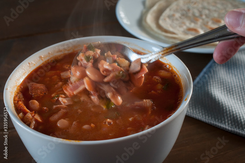 Frijoles charros or charros beans mexican traditional food withy flour tortillas on the saide, frijoles with chorizo bacon and onions spicy food
