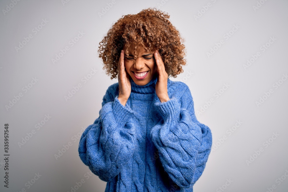 Young beautiful african american woman wearing turtleneck sweater over white background with hand on headache because stress. Suffering migraine. Young beautiful african american woman wearing turtleneck sweater over white background with hand on headache because stress. Suffering migraine.