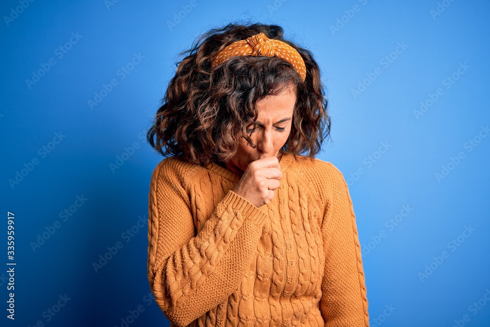 Middle age beautiful woman wearing casual yellow sweater over isolated yellow background feeling unwell and coughing as symptom for cold or bronchitis. Health care concept. Middle age beautiful woman wearing casual yellow sweater over isolated yellow background feeling unwell and coughing as symptom for cold or bronchitis. Health care concept.