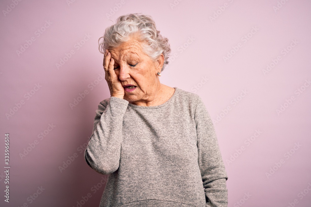 Senior beautiful woman wearing casual t-shirt standing over isolated pink background Yawning tired covering half face, eye and mouth with hand. Face hurts in pain. Senior beautiful woman wearing casual t-shirt standing over isolated pink background Yawning tired covering half face, eye and mouth with hand. Face hurts in pain.