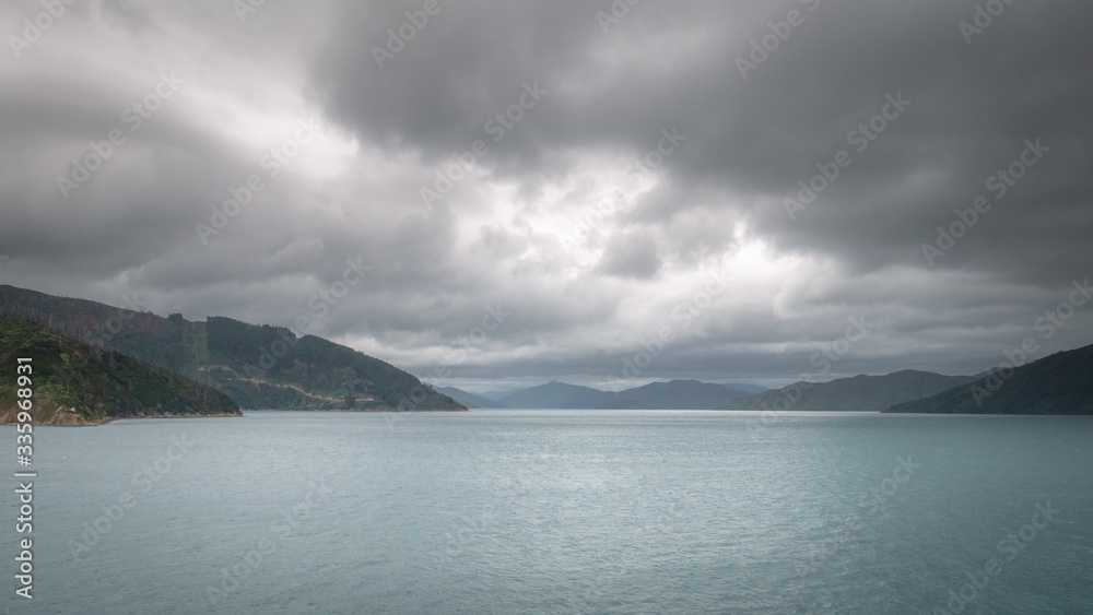 Views on ocean´s strait during overcast day while sailing on boat. Taken on ferry heading from North to South Island, New Zealand