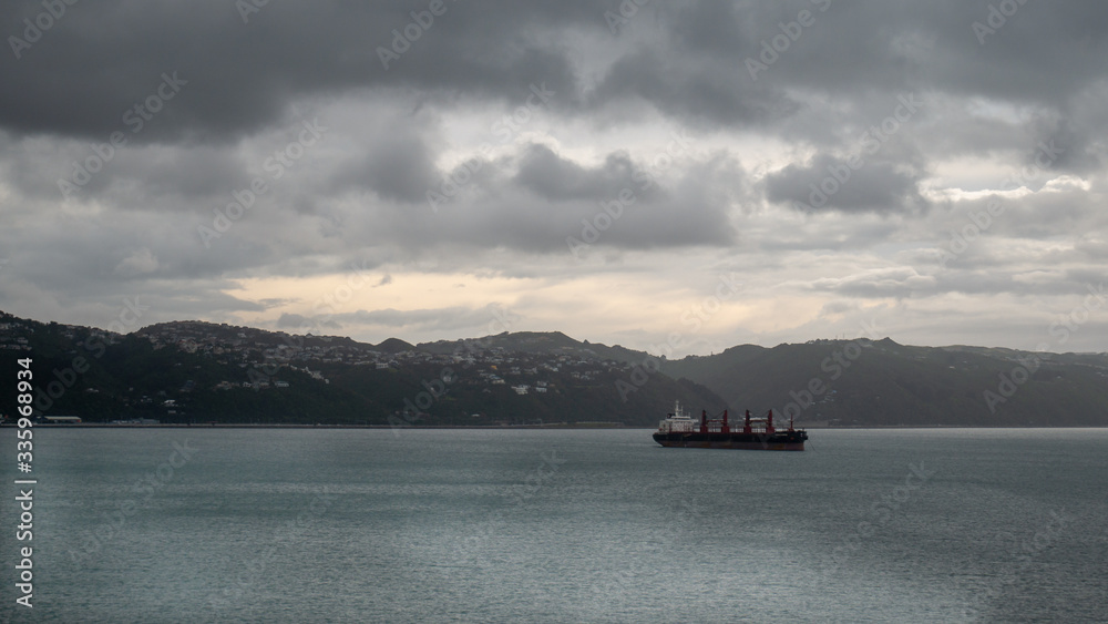 Transport ship sailing on ocean during overcast day. Taken on ferry heading from North to South Island, New Zealand