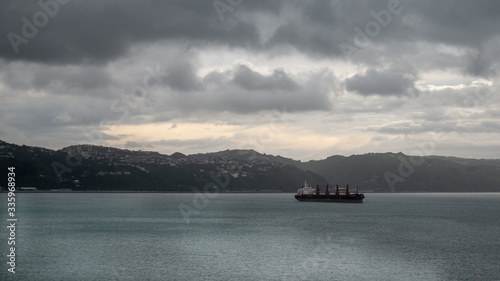 Transport ship sailing on ocean during overcast day. Taken on ferry heading from North to South Island, New Zealand