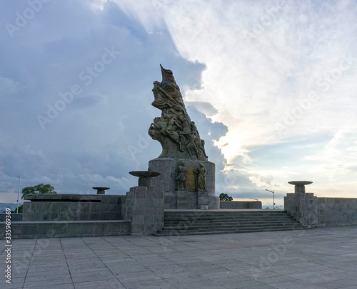 Statue enlighted by a beautiful cloudy sky