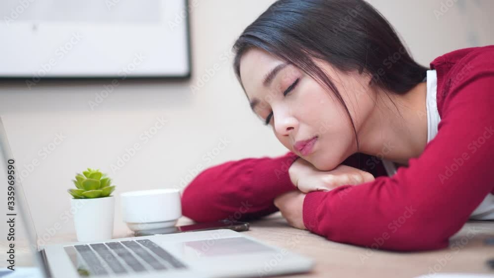 close-up bored Asian female with computer laptop working at home. close-up bored Asian female with computer laptop working at home.