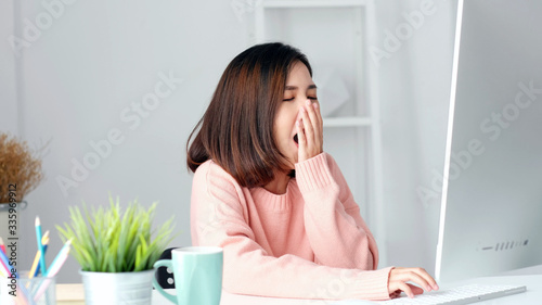Working from home, Young asian woman yawn as exhausted from working with computer at home office, Asia girl overworked from study online class, Female people business, education technology lifestyle photo