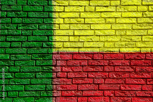 Colorful background and texture depiction of country flag on a brick wall.  © Jim