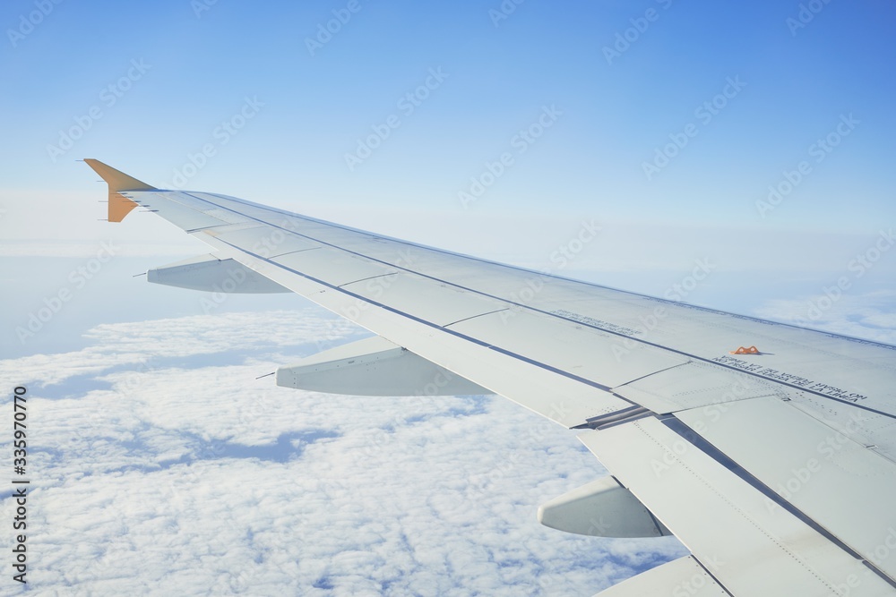 Cloudscape from window airplane, landscape of wing plane on a cloudy sky Cloudscape from window airplane, landscape of wing plane on a cloudy sky