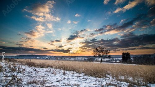 Beautiful sunrise of a  hillside meadow overlooking fields and farmland in Pennsylvania during winter photo