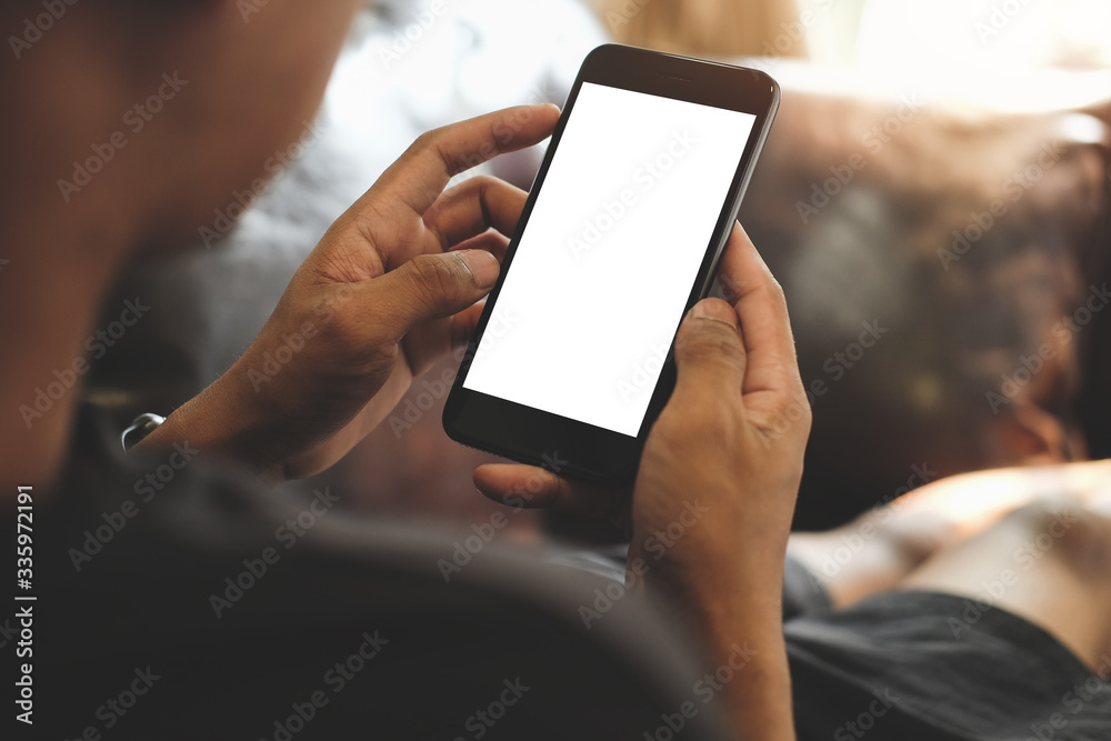 © wattana - Cropped shot view of man hands holding smart phone with blank copy space screen for your text message or information content, female reading text message on cell telephone during in urban setting. © wattana - Cropped shot view of man hands holding smart phone with blank copy space screen for your text message or information content, female reading text message on cell telephone during in urban setting.