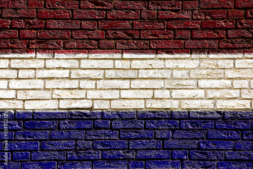 Colorful background and texture depiction of country flag on a brick wall.  photo