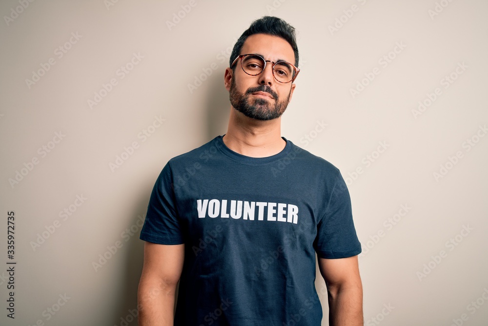 Handsome man with beard wearing t-shirt with volunteer message over white background looking sleepy and tired, exhausted for fatigue and hangover, lazy eyes in the morning. Handsome man with beard wearing t-shirt with volunteer message over white background looking sleepy and tired, exhausted for fatigue and hangover, lazy eyes in the morning.